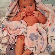 Mirna Guadalupe is registered to the contest to win money with this photo: animal_print, baby, baby_seat, barefoot, blanket, child, comfort, curious, cute, floral_pattern, indoors, infant, lying_down, pastel_colors, portrait, skin, small_hands, soft_texture, wooden_floor, young_child