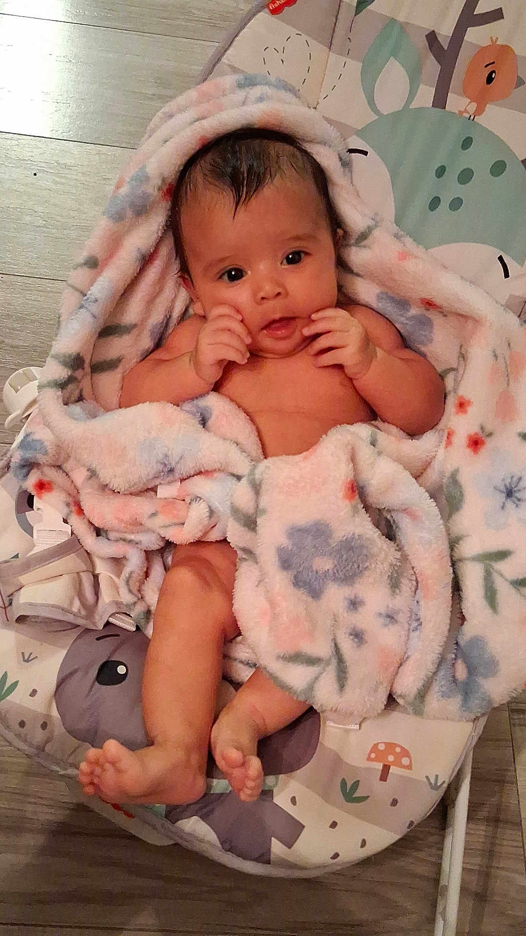 Mirna Guadalupe is registered to the contest to win money with this photo: animal_print, baby, baby_seat, barefoot, blanket, child, comfort, curious, cute, floral_pattern, indoors, infant, lying_down, pastel_colors, portrait, skin, small_hands, soft_texture, wooden_floor, young_child
