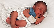Eliam is registered to the contest to win money with this photo: newborn, baby, sleeping, blanket, pacifier, mittens, infant, blue_onesie, rest, peaceful, soft, white_background, cute, small, human, portrait, cozy, tender, child, wrapped