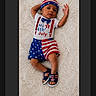 Eliam is registered to the contest to win money with this photo: baby, infant, child, 4th_of_july, patriotic, clothing, hat, footwear, lying_down, indoor, portrait, cute, celebration, american_flag, stars, stripes, soft_texture, white_background, one_person, baby_boy