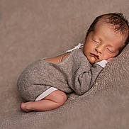 Joseph participe au concours pour gagner de l'argent avec cette photo : newborn, baby, sleeping, infant, cozy, knitted_outfit, beige, blanket, soft_texture, peaceful, cute, portrait, child, resting, warm, small, delicate, toddler, indoors, closeup