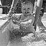 baby, child, water, splashing, pool, hands, smiling, happy, playing, outdoor, summer, fun, person, sitting, waterdroplets, black_and_white, joy, parent, support, cute