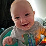 Ryland is registered to the contest to win money with this photo: baby, child, smiling, high_chair, food_on_face, dinosaur_shirt, indoor, happy, young_child, messy, person, cute, toddler, clothing, face, seat, playful, home, infant, portrait