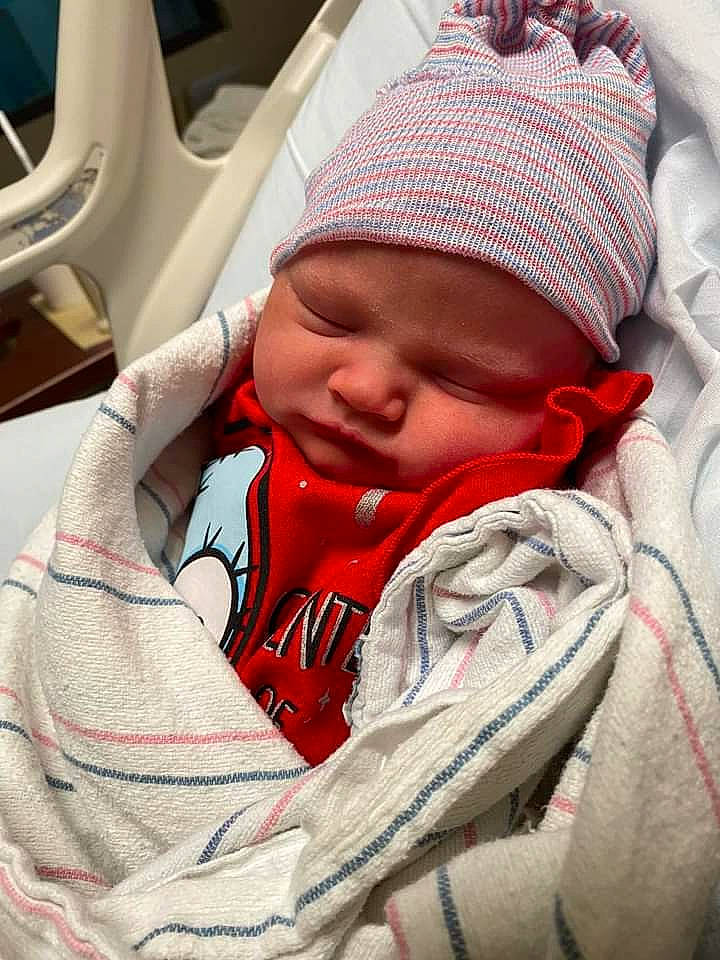 Lilly is registered to the contest to win money with this photo: baby, baby_products, baby_safety, baby_sleeping, baby_toddler_clothing, beanie, cap, carmine, cheek, child, comfort, headwear, knit_cap, linens, mouth, nap, person, sitting, skin, sleep