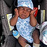 baby, bottle, car_seat, closed_eyes, clothing, cozy, face, hat, indoors, infant, milk, newborn, onesie, photography, portrait, safety_labels, seated, sleeping, socks, vehicle