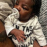 Messiah joined the competition — help win amazing prizes! baby, infant, child, portrait, pacifier, curly_hair, dark_skin, lying_down, couch, blanket, pillow, white_outfit, long_sleeves, hand, fingers, legs, indoor, cozy, close_up, relaxed