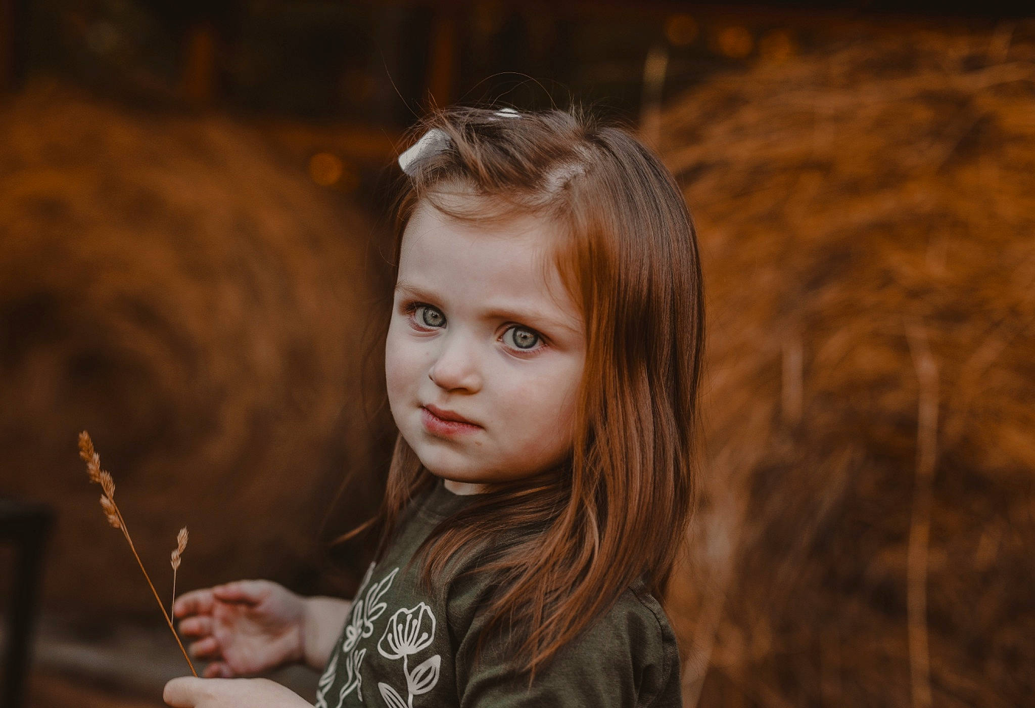 Charlee is registered to the contest to win money with this photo: beauty, brown, brown_hair, child, child_model, face, flash_photography, fun, grass, happy, lip, long_hair, people_in_nature, person, portrait, portrait_photography, sitting, soil, t_shirt, toddler