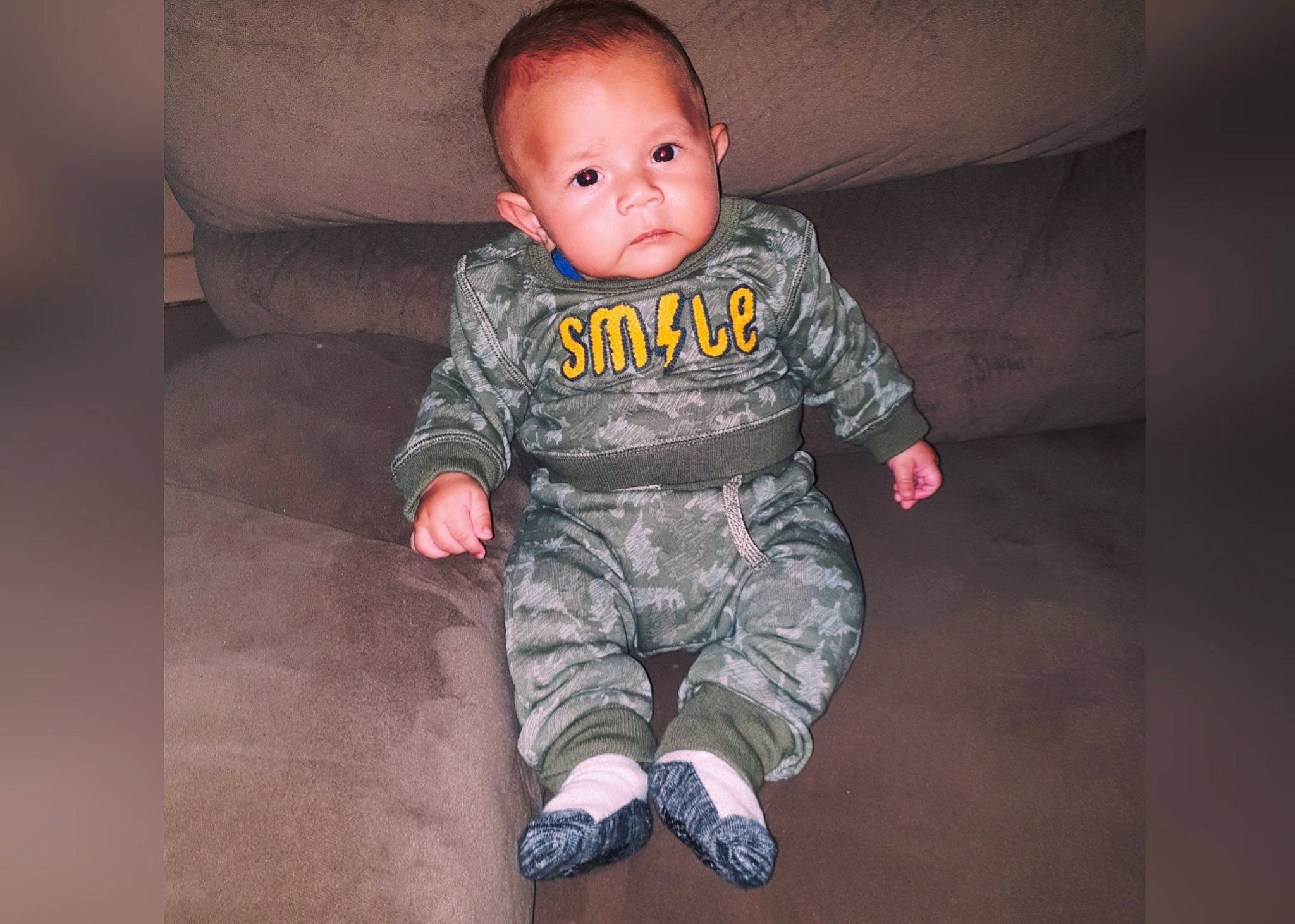Sebastien is registered to the contest to win money with this photo: baby, baby_toddler_clothing, camouflage, cheek, child, fun, head, military_camouflage, outerwear, person, skin, sleeve, smile, standing, toddler