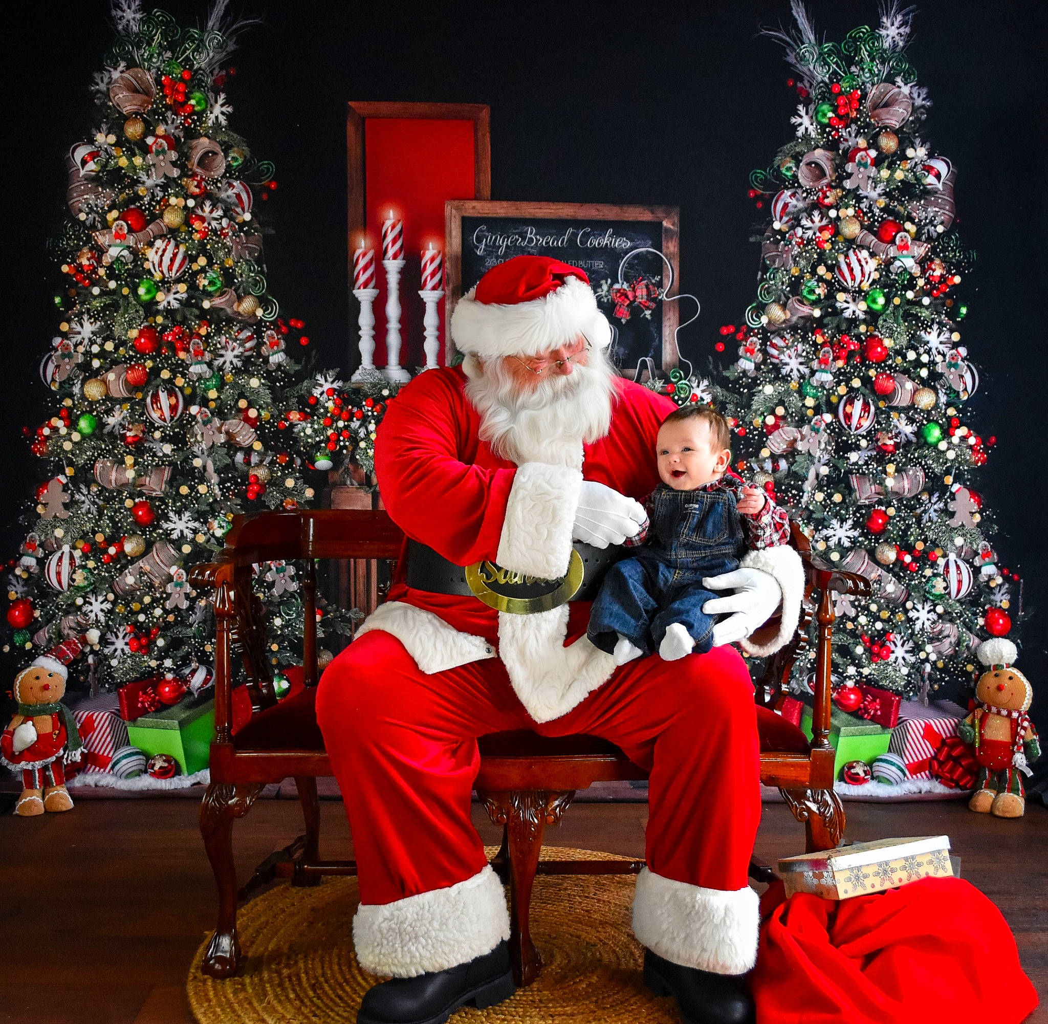 Colton is registered to the contest to win money with this photo: christmas, christmas_decoration, christmas_ornament, christmas_tree, costume_hat, event, fun, green, happy, hat, holiday, holiday_ornament, lap, ornament, person, red, santa_claus, tradition, tree, white