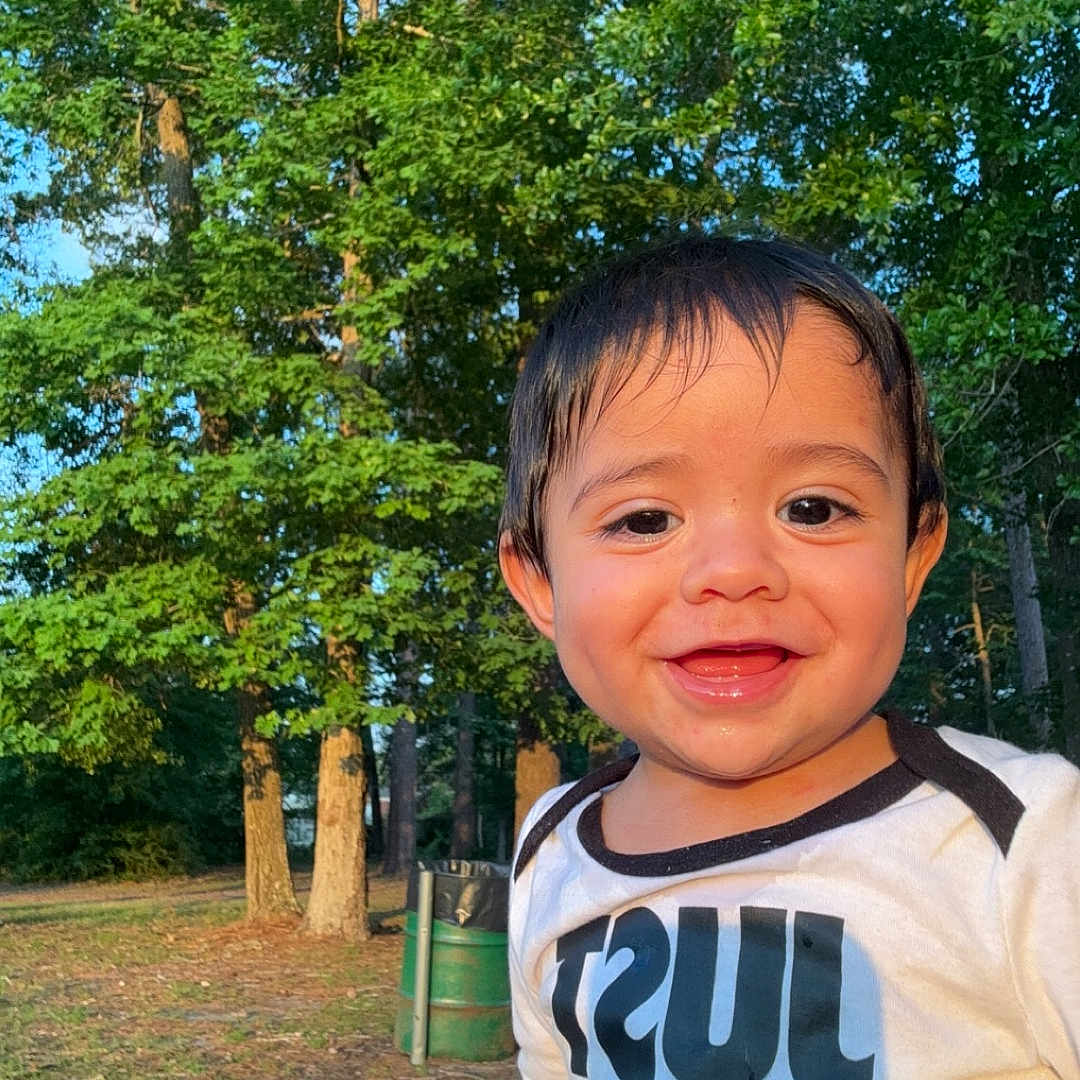 Bellame is registered to the contest to win money with this photo: baby, clothing, face, grass, grove, head, land, nature, outdoors, park, path, person, photography, plant, portrait, summer, t_shirt, tree, vegetation, woodland