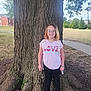 Olivia joined the competition — help win amazing prizes! backpack, casual_clothing, child, colorful_shoes, daytime, girl, glasses, grass, happy, love, nature, outdoor, park, person, sidewalk, smile, tree, trunk, tshirt, young