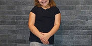 Olivia is registered to the contest to win money with this photo: balance, black_shirt, brick_wall, casual_clothing, child, fashion, full_body, girl, gray_leggings, happy, headband, indoor, pink_bow, playful, portrait, posing, smiling, standing, young, youth