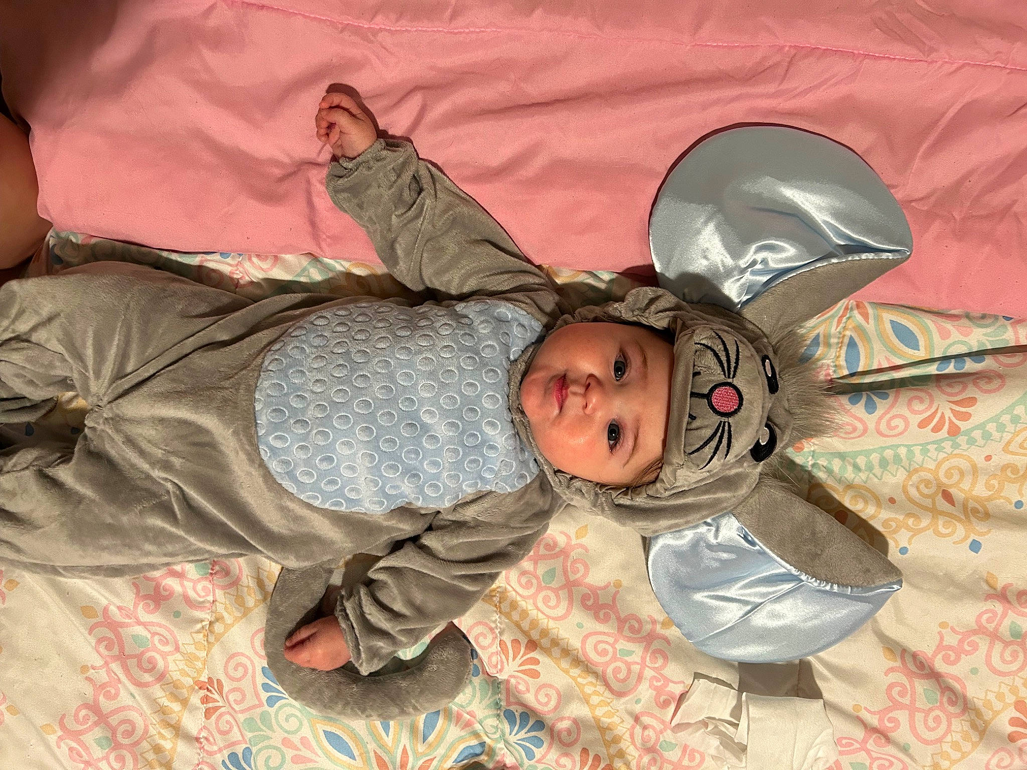 Azlynn is registered to the contest to win money with this photo: baby, baby_toddler_clothing, bed, bedtime, child, comfort, flooring, fun, headwear, linens, military_camouflage, nap, pattern, person, personal_protective_equipment, room, sitting, sleep, sleeve, smile