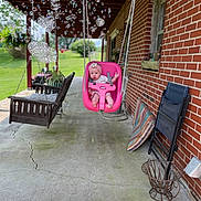 Rory joined the competition — help win amazing prizes! baby, swing, porch, bubbles, brick_wall, outdoor, child, seat, pink, grass, plants, window, chair, concrete, sunlight, rope, flower_headband, cushion, folding_chair, playtime