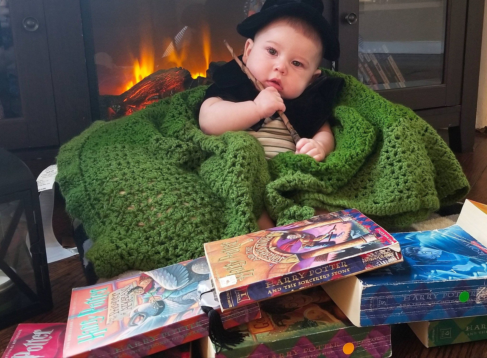 Sylas is registered to the contest to win money with this photo: child, comfort, couch, electronic_device, event, fun, fur, grass, holiday, linens, living_room, person, publication, reading, room, sitting, snapshot, toddler, wool