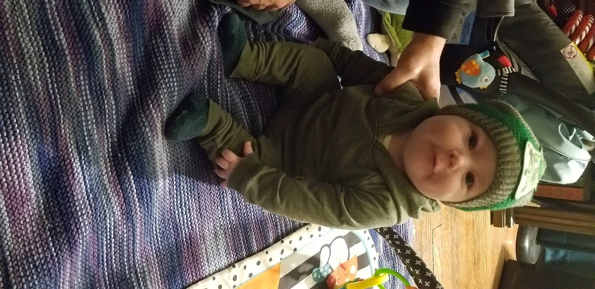 Sylas is registered to the contest to win money with this photo: baby, child, fun, grass, green, headwear, leisure, linens, pattern, person, plaid, room, sitting, toddler, tree, wood