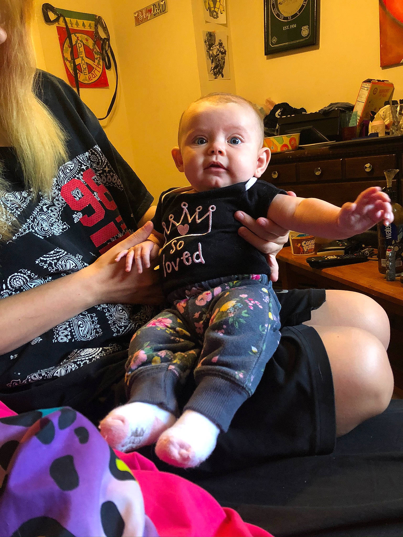 Skyla is registered to the contest to win money with this photo: arm, baby, child, footwear, joint, leg, person, pink, room, shoe, shoulder, sitting, skin, t_shirt, tattoo, toddler, vacation