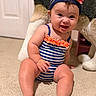 baby, infant, smile, sitting, striped_swimsuit, headband, flower, carpet, indoor, plush_toy, cute, child, happy, skin, person, cheeks, toes, legs, furniture, room