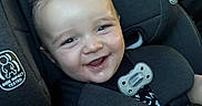 Draco joined the competition — help win amazing prizes! baby, black_clothing, car, car_seat, child, close_up, eyes, face, family_trip, graco, happy, infant, pacifier, portrait, red_shirt, safety_harness, seated, smiling, teeth, vehicle_interior