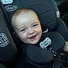 baby, child, infant, smiling, happy, portrait, car, car_seat, safety_harness, graco, pacifier, vehicle_interior, seated, close_up, face, eyes, teeth, black_clothing, red_shirt, family_trip