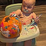 Draco joined the competition — help win amazing prizes! baby, child, high_chair, pumpkin, painting, paint, paintbrush, pacifier, indoor, home, wooden_floor, creative, messy, colorful, art_project, sitting, portrait, blonde_hair, socks, autumn