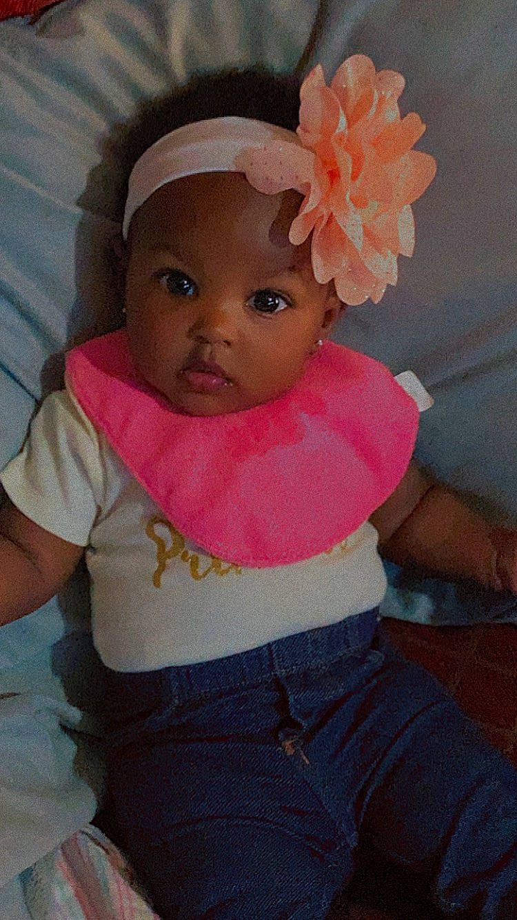 Azaria is registered to the contest to win money with this photo: baby, baby_toddler_clothing, cap, cheek, chin, eye, finger, fun, happy, hat, headgear, human_body, lip, mouth, nose, person, pink, skin, sleeve, t_shirt