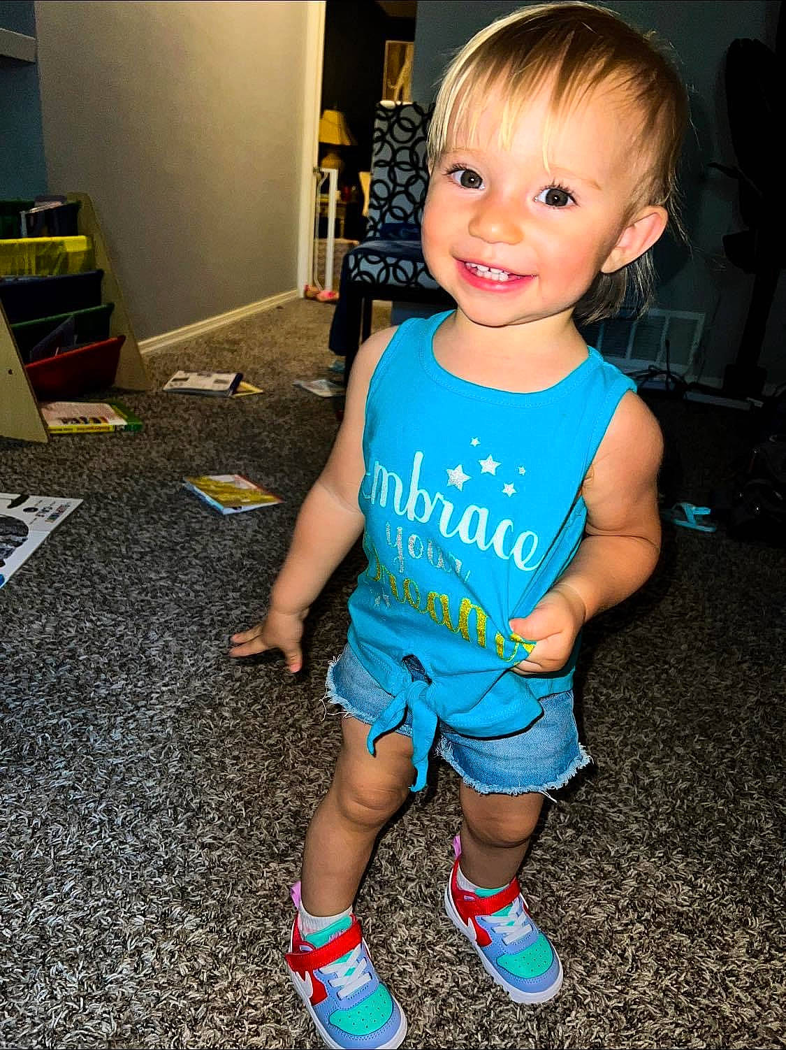 Sofia is registered to the contest to win money with this photo: baby_toddler_clothing, child, electric_blue, floor, flooring, fun, happy, human_leg, joint, joy, knee, person, skin, sleeve, smile, sock, sportswear, standing, t_shirt, thigh