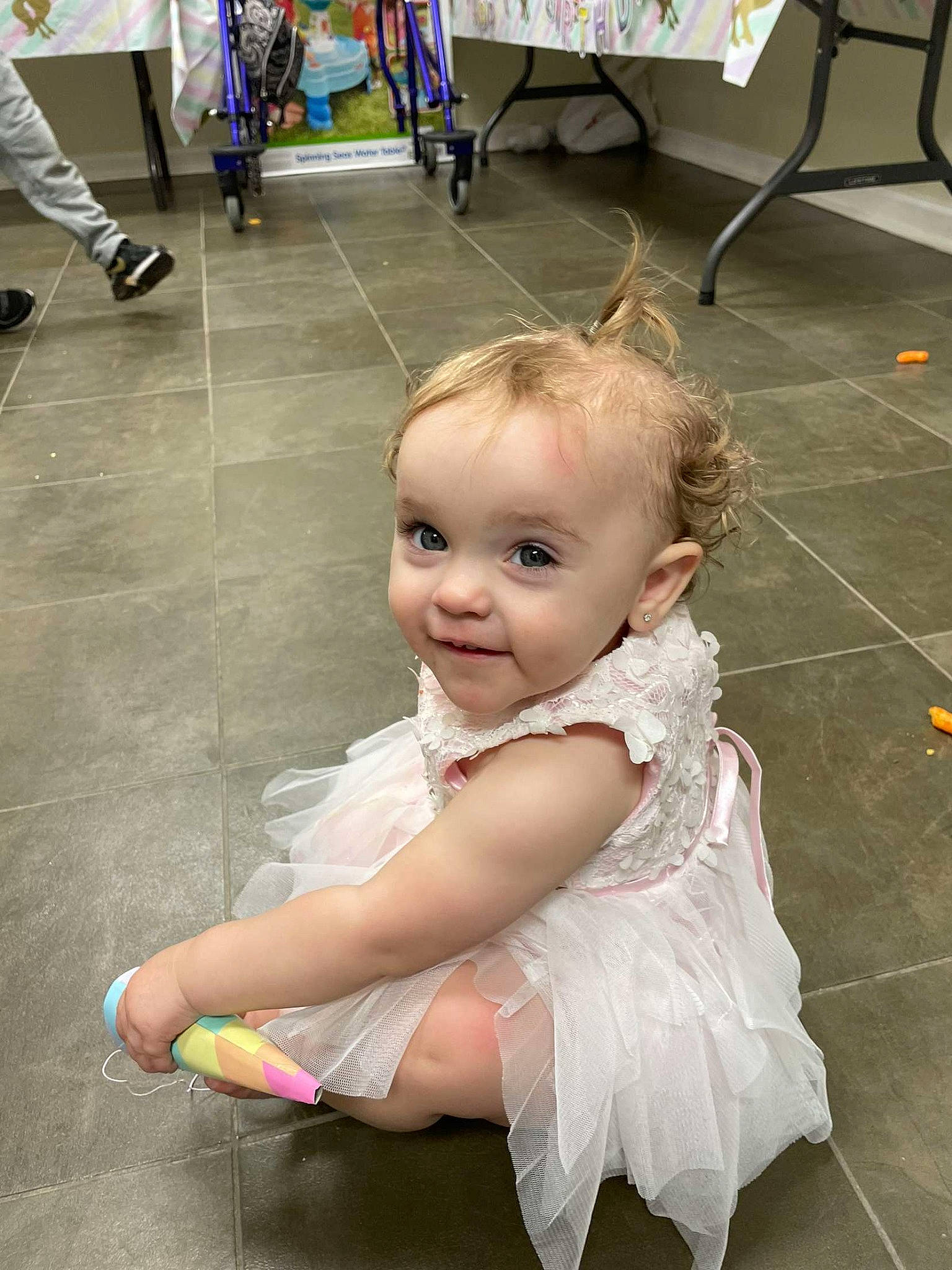 Emilee is registered to the contest to win money with this photo: baby, baby_toddler_clothing, chair, child, costume, event, eye, floor, flooring, foot, fun, happy, human_leg, joint, joy, leisure, person, sandal, sidewalk, sitting