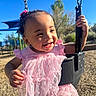 Zariah is registered to the contest to win money with this photo: blue_sky, chains, child, curly_hair, earrings, face, frilly_dress, girl, hair_bow, happy, outdoor, pink_dress, play_equipment, playground, portrait, smiling, summer, sunlight, swing, toddler