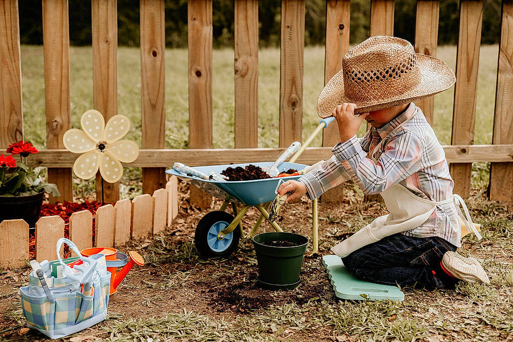 Preston joined the competition — help win amazing prizes! cap, fence, flower, flowerpot, fun, garden_tool, glasses, grass, hat, leisure, mammal, people_in_nature, person, plant, summer, sun_hat, tire, toddler, vertebrate, wheel