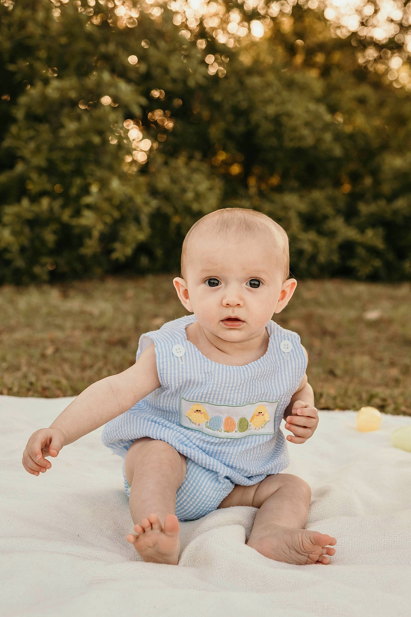 Paxtyn is registered to the contest to win money with this photo: baby, baby_toddler_clothing, barefoot, cheek, child, eye, face, flash_photography, grass, happy, iris, leisure, people_in_nature, person, plant, sitting, skin, sleeve, summer, toddler