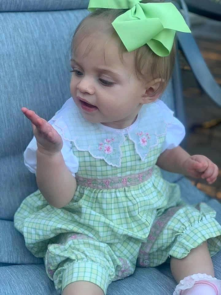Emma Rose is registered to the contest to win money with this photo: baby, baby_toddler_clothing, cheek, dress, eye, face, facial_expression, finger, green, hairstyle, hand, head, headgear, iris, lip, organ, person, pink, product, skin