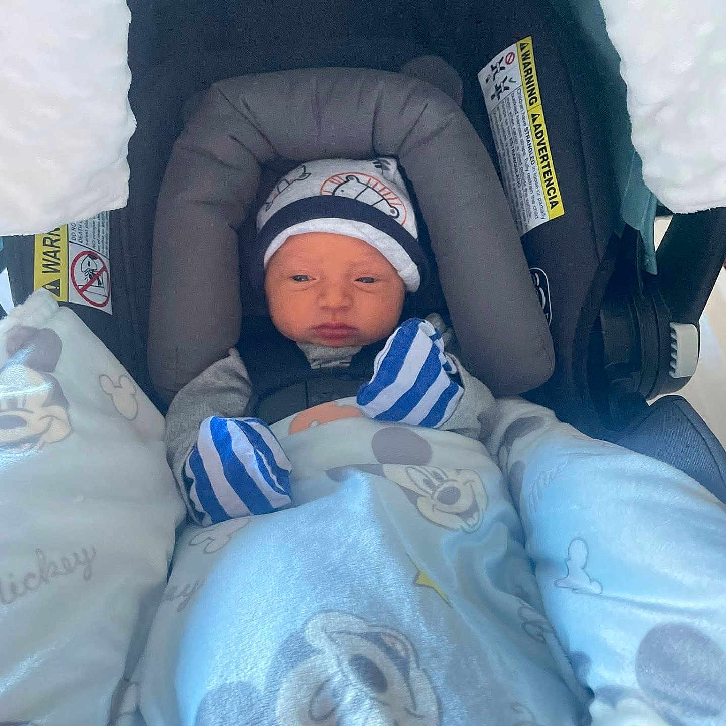 Kalvin joined the competition — help win amazing prizes! baby, blanket, blue, car_seat, child, clothing, cozy, cute, face, gray, hat, indoors, infant, mickey_mouse, mittens, newborn, seatbelt, soft, striped, toddler