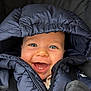 baby, child, smile, open_mouth, two_teeth, blue_eyes, hood, puffer_jacket, zipper, jacket, coat, car_seat, seatbelt, happy, cheeks, eyelashes, portrait, closeup, winter, adorable