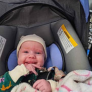 Sawyer is registered to the contest to win money with this photo: accessories, baby, bonnet, cap, clothing, coat, face, glove, happy, hat, head, homedecor, jacket, newborn, person, photography, portrait, sleeping, smile, stroller