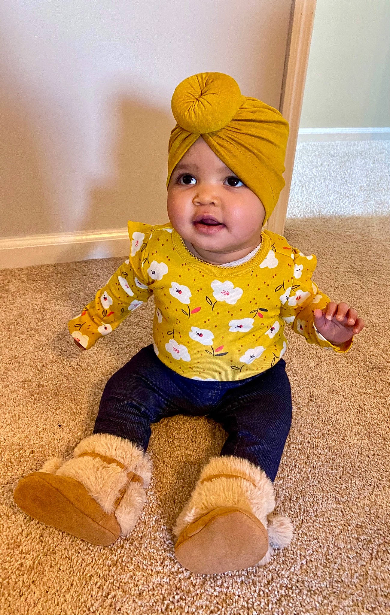Emerie joined the competition — help win amazing prizes! baby, baby_toddler_clothing, cap, cheek, child, face, fashion_accessory, flooring, fun, happy, head, headwear, human_body, knit_cap, outerwear, person, sitting, sleeve, sock, toddler
