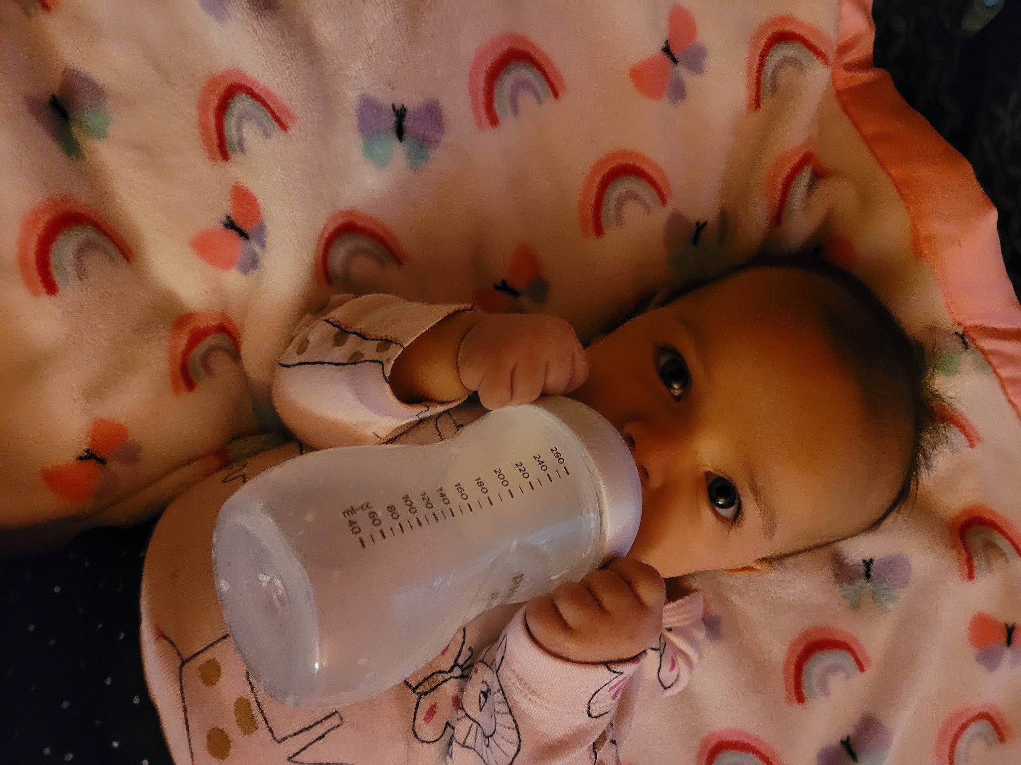 Evie is registered to the contest to win money with this photo: baby, beauty, bottle, cheek, child, drinkware, eye, eyebrow, eyelash, fluid, head, iris, lip, nail, nose, person, plastic_bottle, skin, toddler, toy