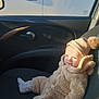 baby, child, car_interior, seat, clothing, hat, mittens, socks, cozy, warm, sunlight, cute, portrait, smile, infant, people, vehicle, window, car_door, seat_cover
