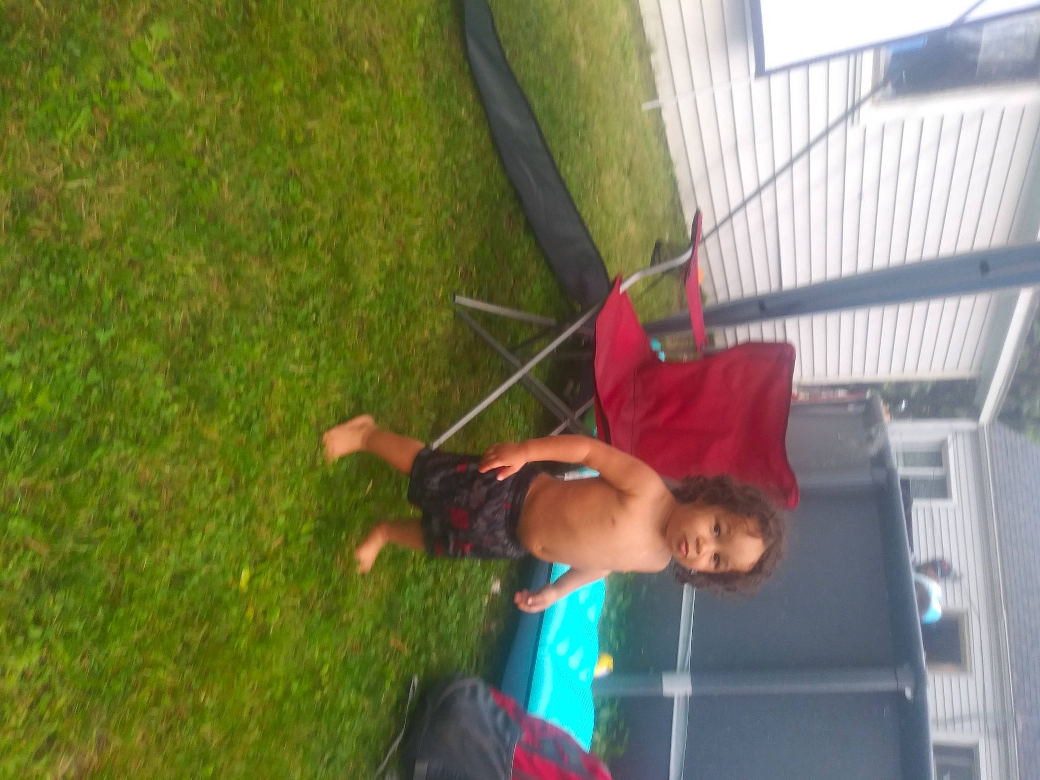 Tariq is registered to the contest to win money with this photo: adventure, elbow, fun, grass, grassland, leisure, outdoor_play_equipment, person, plant, recreation, rope, shade, shorts, swing, t_shirt, tree, window