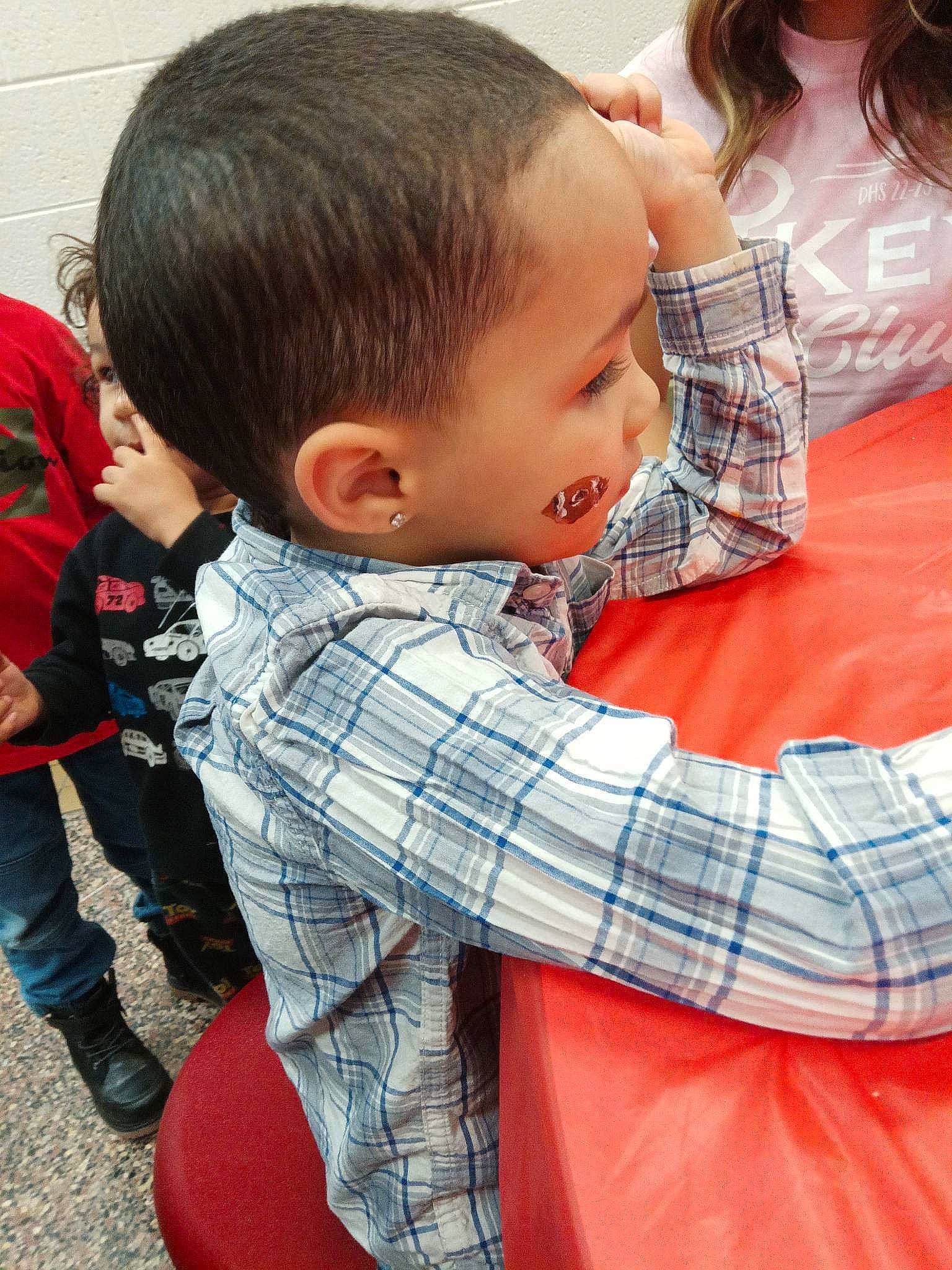 Torian Jr. is registered to the contest to win money with this photo: baby, carmine, child, fun, hair, happy, head, joint, leisure, neck, pattern, person, plaid, play, product, red, sitting, sleeve, t_shirt, tartan