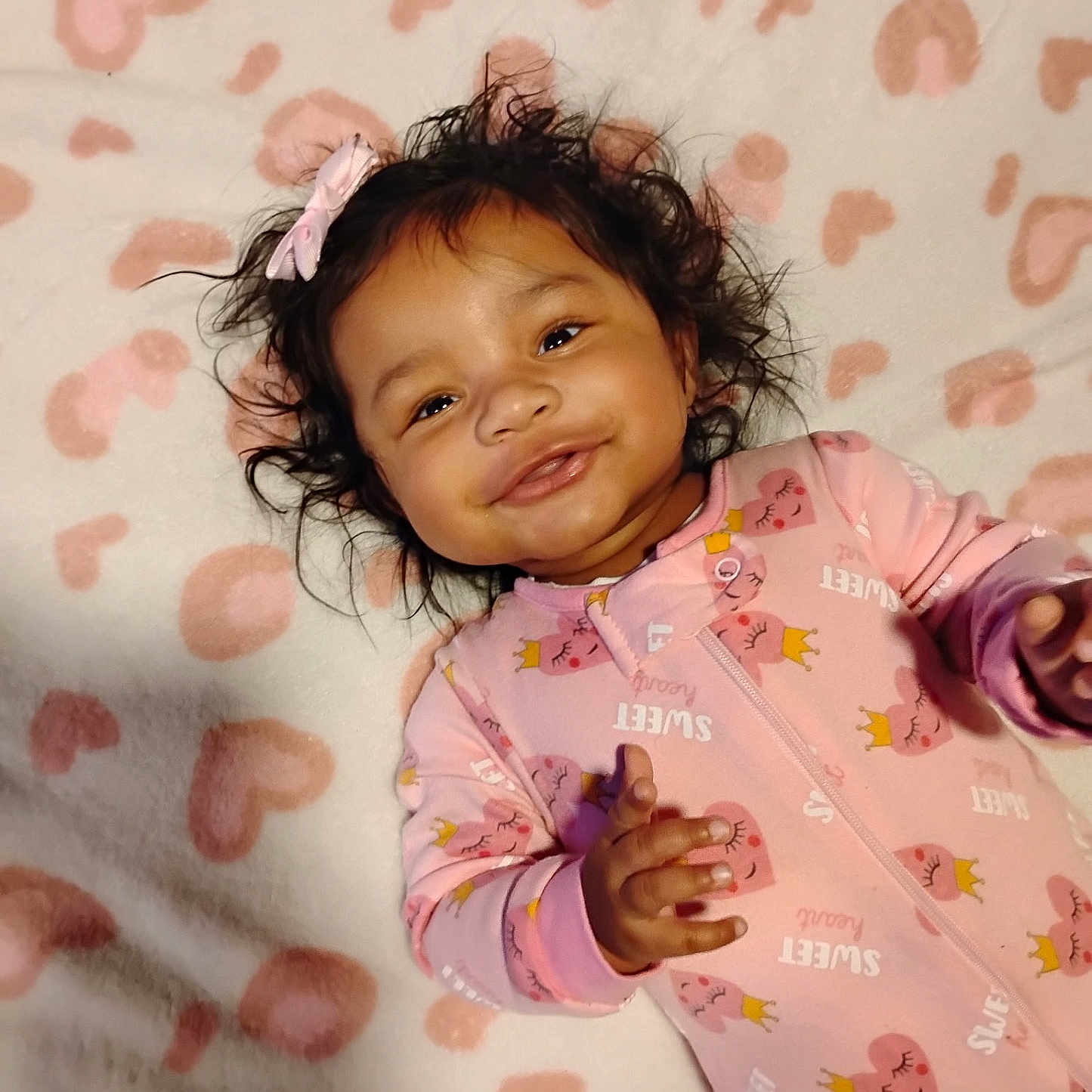 Jayaraj joined the competition — help win amazing prizes! adorable, baby, blanket, bow, child, cozy, cute, face, happy, heart_pattern, indoor, infant, lying_down, onesie, pink, portrait, sleepwear, smiling, soft, young_child