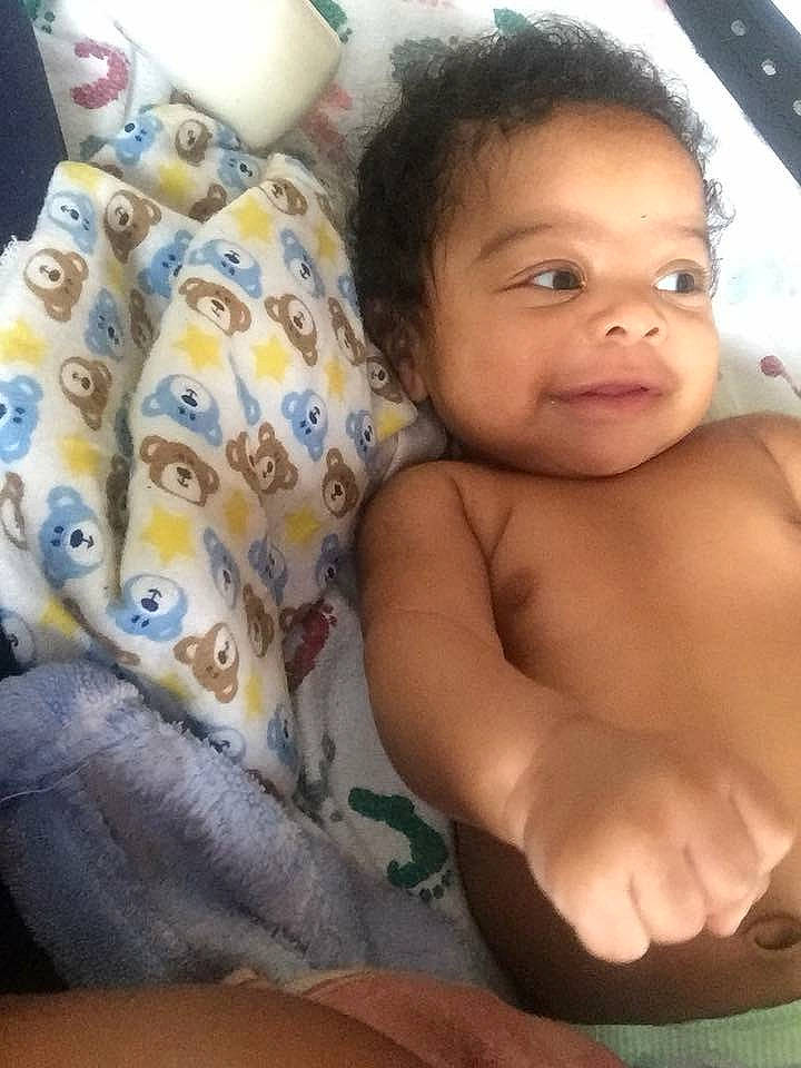 Samir is registered to the contest to win money with this photo: arm, bedtime, black_hair, cheek, child, eye, face, finger, forehead, hand, head, infant, lip, mouth, muscle, nose, person, product, selfie, skin