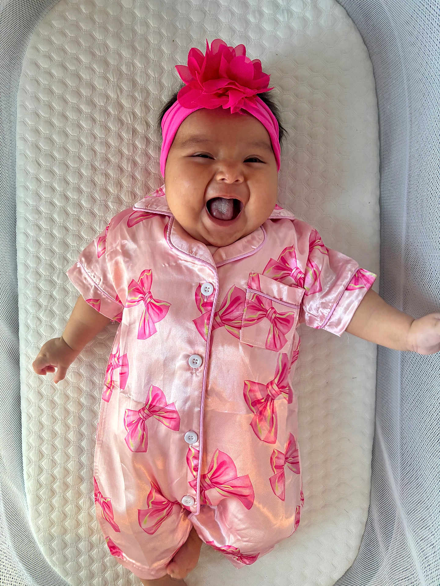 Brixlei joined the competition — help win amazing prizes! baby, infant, pink_outfit, headband, flower, smiling, laughing, cute, lying_down, cushion, textured_background, child, happy, one_person, indoors, soft_lighting, portrait, sleepsuit, newborn, playful