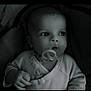 baby, infant, pacifier, clothing, face, hand, portrait, monochrome, black_and_white, child, cute, young, indoors, closeup, expression, person, sitting, soft_light, newborn, candid