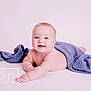 baby, babylaughing, blanket, bodypart, clothing, dress, face, finger, hand, happy, head, laughing, newborn, person, photography, portrait, quilt, sitting, smile, towel