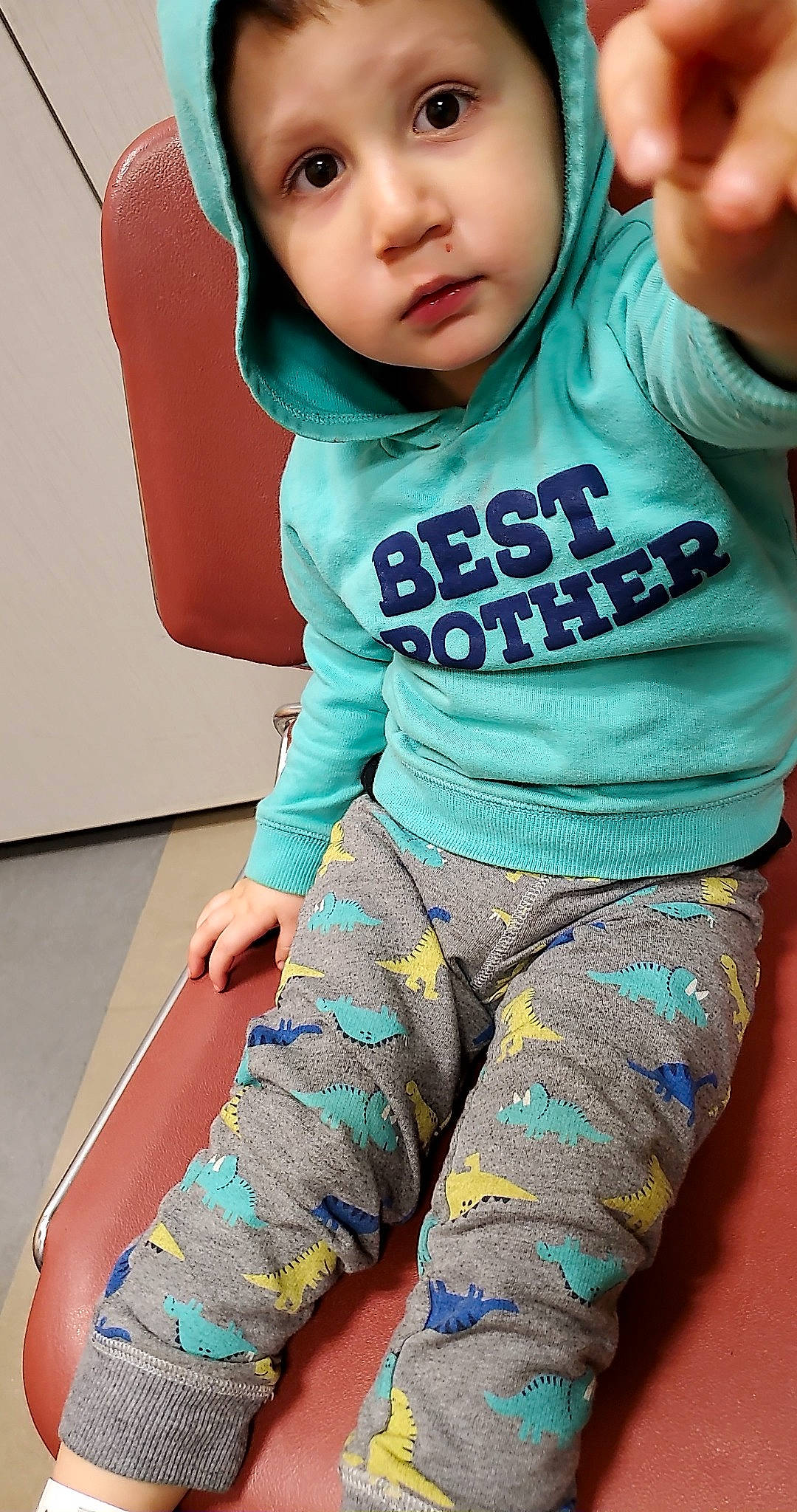 Levi is registered to the contest to win money with this photo: arm, baby_toddler_clothing, blue, clothing, green, hairstyle, hand, human_body, joint, leg, muscle, neck, organ, outerwear, person, shoulder, sleeve, standing, t_shirt, waist