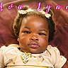 Ava joined the competition — help win amazing prizes! baby, child, portrait, face, hair_buns, bows, clothing, gold, heart, expressionless, indoor, soft_lighting, close_up, infant, person, cute, adorable, pink_text, name_overlay, background_blur