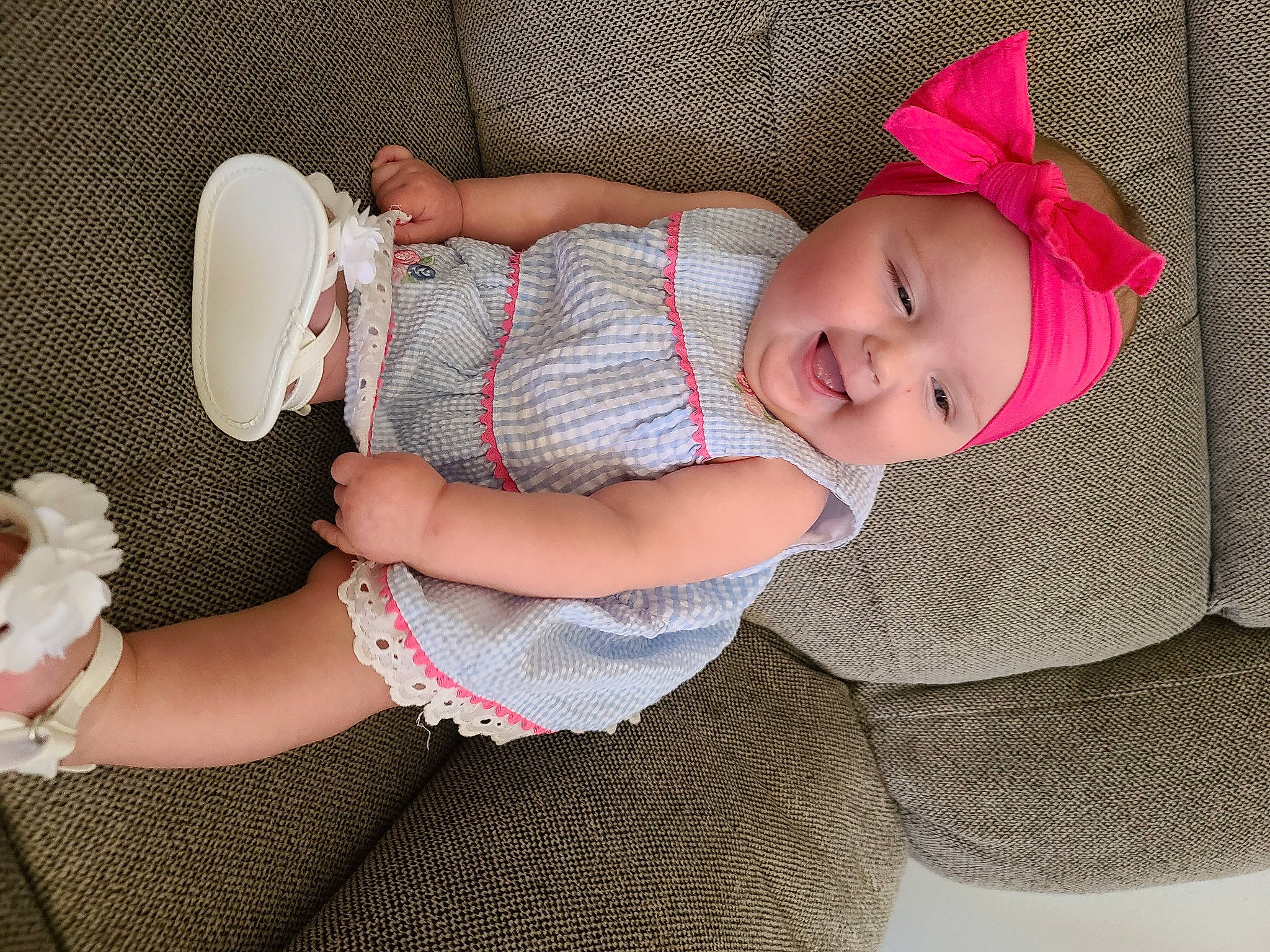 Rylee is registered to the contest to win money with this photo: baby, baby_carriage, baby_toddler_clothing, child, comfort, eye, finger, hand, headgear, headwear, human_body, human_leg, lap, leg, nail, pattern, person, pink, skin, sleeve