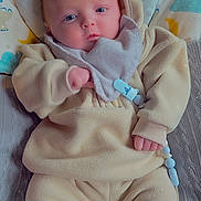 Marley joined the competition — help win amazing prizes! baby, infant, pacifier, clothing, blanket, pillow, blue_eyes, indoor, cute, soft_fabric, child, newborn, wearing, accessory, sleepwear, lying_down, comfort, warm, hand, face