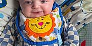 Marley joined the competition — help win amazing prizes! baby, smiling, infant, bib, checkered_clothing, blue, white, plush, cushion, face, head, happy, child, portrait, lying_down, soft_toys, baby_bedding, cute, teeth, hand